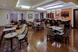a restaurant with tables and chairs and a television at Hampton Inn Richmond-West Innsbrook in Broad Meadows