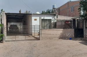 a building with a gate in front of a building at Depto B in Rincon de los Sauces