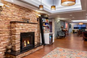 a fireplace in a lobby with a brick wall at Hampton Inn South Hill in South Hill