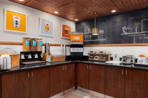 a kitchen with a counter with a coffee shop at Hampton Inn South Hill in South Hill