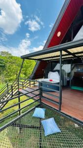 a chicken coop on the deck of a house at Cabaña El Encanto in El Porvenir