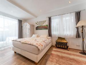 a bedroom with a bed and a large window at Smaragdherz in Brandberg