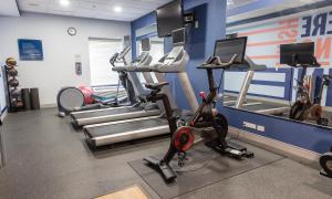 a gym with several tread machines and a treadmill at Hampton Inn Williamsport in Williamsport