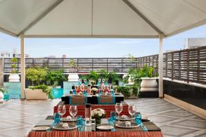 a table with wine glasses on top of a balcony at Hilton Jaipur in Jaipur