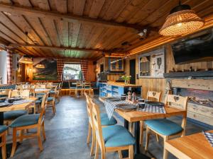 a dining room with wooden tables and chairs at Bergzeit Hollersbach L in Hollersbach im Pinzgau +32 photos