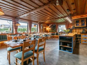 a dining room with wooden tables and chairs at Bergzeit Hollersbach L in Hollersbach im Pinzgau