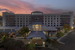 a building with a sign on top of it at Embassy Suites by Hilton Jackson North Ridgeland in Ridgeland