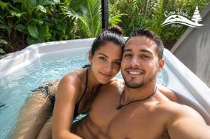 a man and a woman in a bathtub at Cerro Verde Glamping Cartago in Lourdes +2 photos
