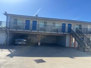 a garage with a car parked in front of a building at Clover motel in Lynwood