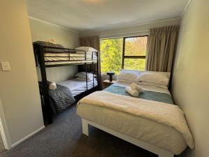 a bedroom with two bunk beds and a window at Taratara retreat in Kaeo +34 photos