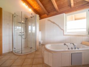 a bathroom with a shower and a tub and a sink at Sonnenwinkel I in Kolsassberg +33 photos