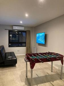 a living room with a table and a couch at C&R Departamentos y Hoteles in Mar del Plata