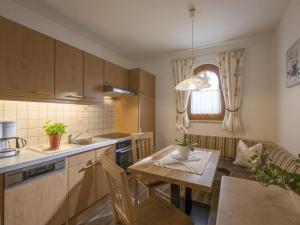 a kitchen with a table and a dining room at Apartment Gartentraum in Itter +29 photos
