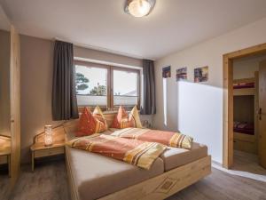 a bedroom with a bed with pillows on it at Apartment Gartentraum in Itter