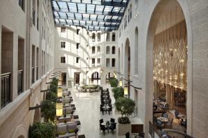 an empty lobby with tables and chairs in a building at Waldorf Astoria Jerusalem in Jerusalem