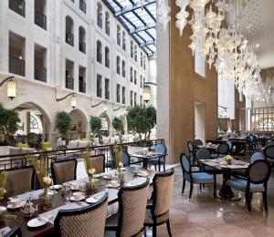 a restaurant with tables and chairs in a building at Waldorf Astoria Jerusalem in Jerusalem