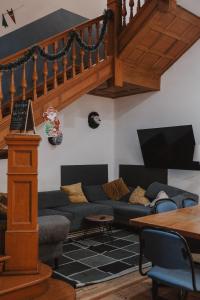 a living room with a couch and a staircase at U-CO Live Roma Norte in Mexico City