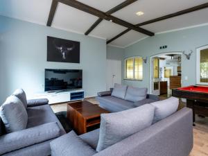 a living room with couches and a pool table at Haslau Large in Hopfgarten im Brixental
