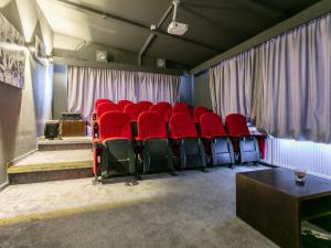 a room with red chairs in front of a curtain at Haslau Large in Hopfgarten im Brixental
