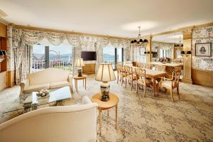 a living room with a table and a dining room at Hilton Gyeongju in Gyeongju