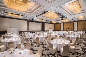a large banquet hall with white tables and chairs at Hilton Gyeongju in Gyeongju +49 photos