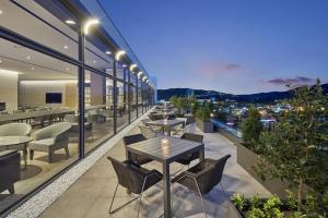 a restaurant with tables and chairs on a building at Hilton Gyeongju in Gyeongju
