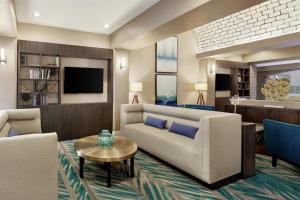 a living room with a couch and a table at Embassy Suites by Hilton Arcadia-Pasadena Area in Arcadia