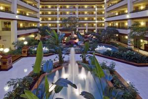 an indoor courtyard with fountains in a hotel at Embassy Suites Lexington in Lexington