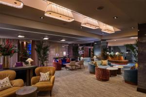 a lobby of a hotel with couches and tables at DoubleTree by Hilton London – West End in London