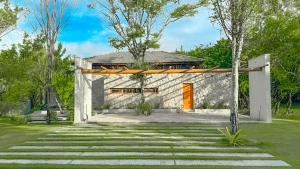 a stone house with an orange door at Orixás Residence -Casa Yemanja Morro in Cairu