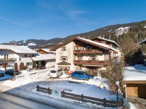 a ski lodge in the mountains with snow on the ground at Maria Rose XXL in Kirchberg in Tirol