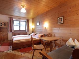 a bedroom with a bed and a table in a room at Maria Rose XL in Kirchberg in Tirol