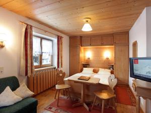 a small room with a bed and a television at Maria Rose XL in Kirchberg in Tirol