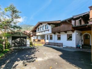 a large white house with a driveway at Pension Schreder XL in Kirchberg in Tirol