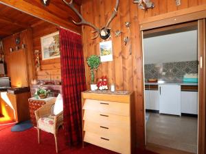 a kitchen with wooden walls and a sliding glass door at Chalet Westermeyr in Mieming