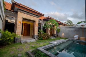 a house with a swimming pool in the yard at Maheeka Villa, Sanur in Sanur