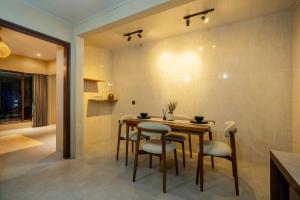 a dining room with a table and chairs at Maheeka Villa, Sanur in Sanur