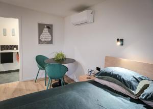 a bedroom with a bed and a table and chairs at Guesthouse on Gardiners in Christchurch
