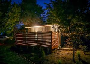 a wooden house with a light on it at night at Guesthouse on Gardiners in Christchurch