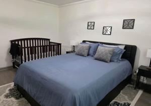 a bedroom with a large bed with blue sheets and pillows at 3BR Home Best of Both-FIFA World Cup-Truist Park in Smyrna