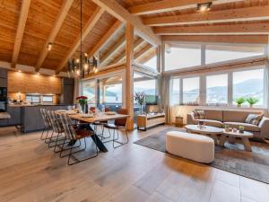 a kitchen and living room with a table and chairs at Grebenzen Lodge Edelblick in Sankt Lambrecht