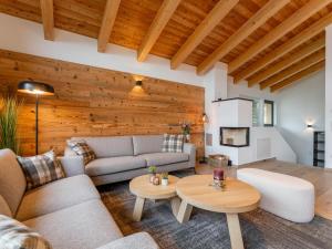 a living room with a couch and a table at Grebenzen Lodge Edelblick in Sankt Lambrecht