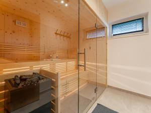 a sauna with a tub and a shower stall at Grebenzen Lodge Edelblick in Sankt Lambrecht +55 photos