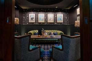 a dining room with a table and chairs at Conrad London St James in London