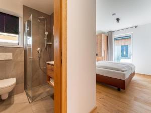 a bathroom with a shower and a bed in a room at Mountain Vista in Sankt Lorenzen ob Murau +50 photos
