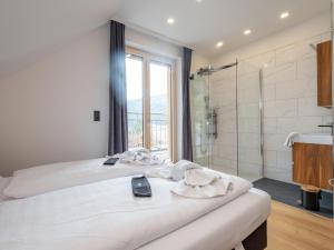a hotel room with a bed and a shower at Doppellodge in Sankt Lorenzen ob Murau +20 photos