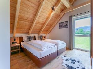 a bedroom with a large bed and a large window at Mountain Vista in Sankt Lorenzen ob Murau