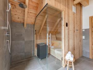 a sauna with a glass shower in a wooden building at Mountain Chalet Dahoam in Sankt Lorenzen ob Murau +51 photos