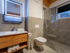 a bathroom with a toilet sink and a shower at Mountain Chalet Aquarius 5A in Sankt Lorenzen ob Murau +64 photos