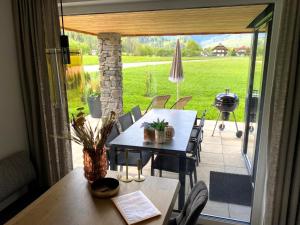 a table and chairs on a patio with a grill at Mountain Chalet Esttes in Sankt Lorenzen ob Murau
